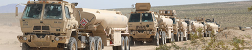 A convoy of HEMTT ground vehicles.