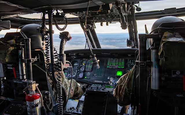 An image of Soldiers piloting a helicopter