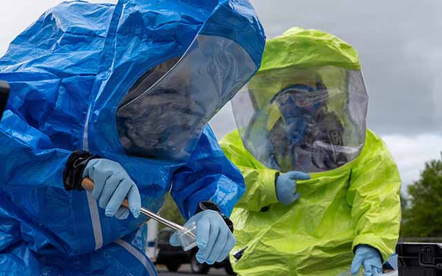 An image of people in HAZMAT suits